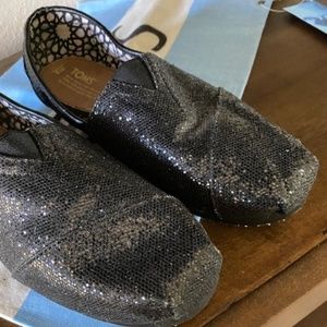 Toms Black Glitter slip on shoes.  Sought after size 8.